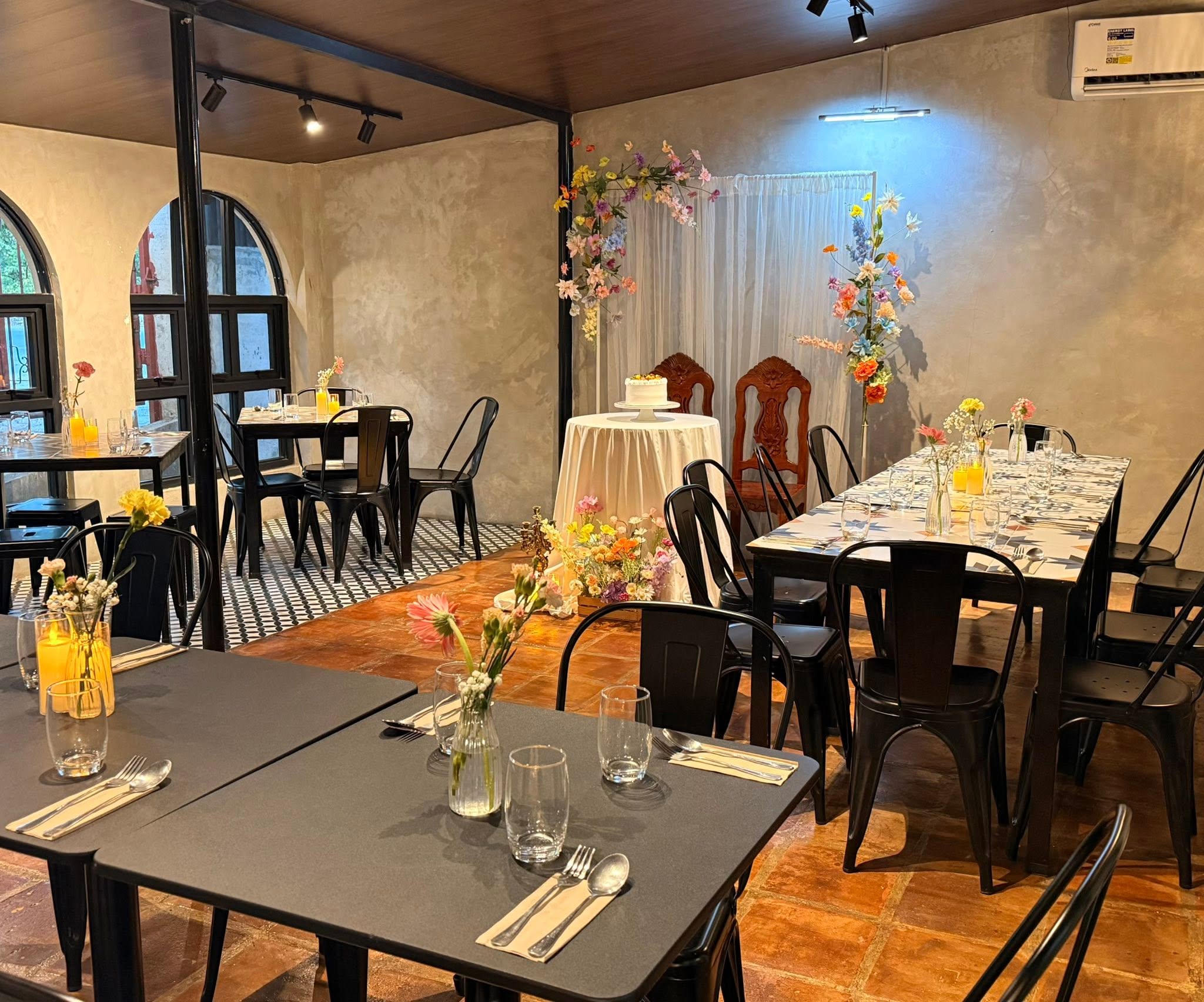 Candlelit tables set with flowers for a private celebration